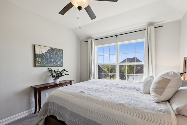 bedroom with vaulted ceiling, carpet floors, and ceiling fan