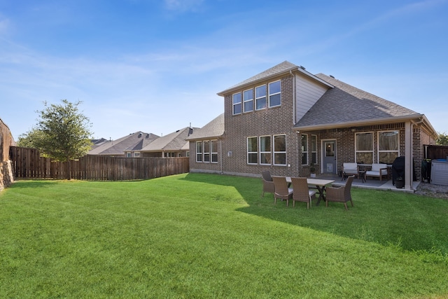 back of property featuring a lawn and a patio