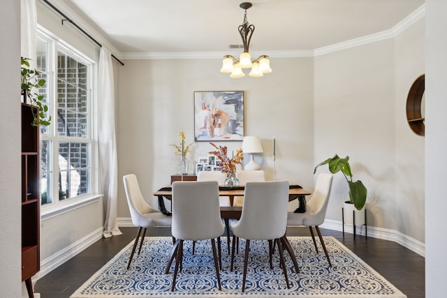 dining area featuring dark hardwood / wood-style flooring, an inviting chandelier, and ornamental molding