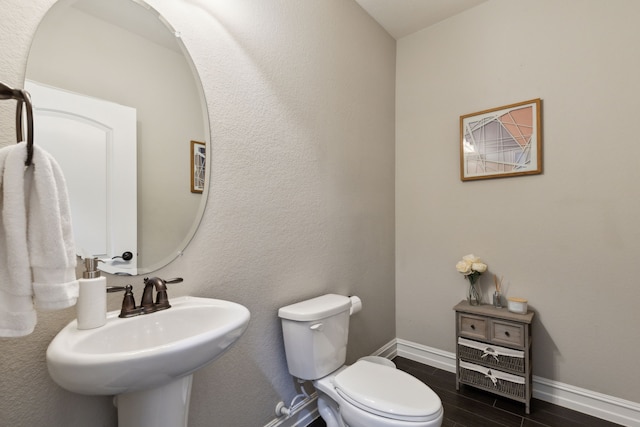 bathroom featuring toilet and sink