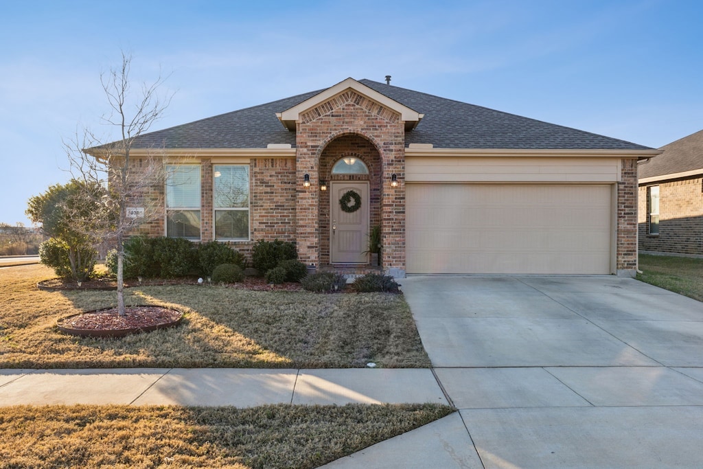 ranch-style home featuring a front yard and a garage