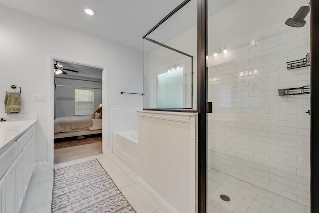 bathroom with ceiling fan, tile patterned floors, a shower with shower door, and vanity