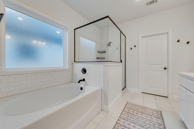 bathroom with plus walk in shower, tile patterned flooring, and vanity