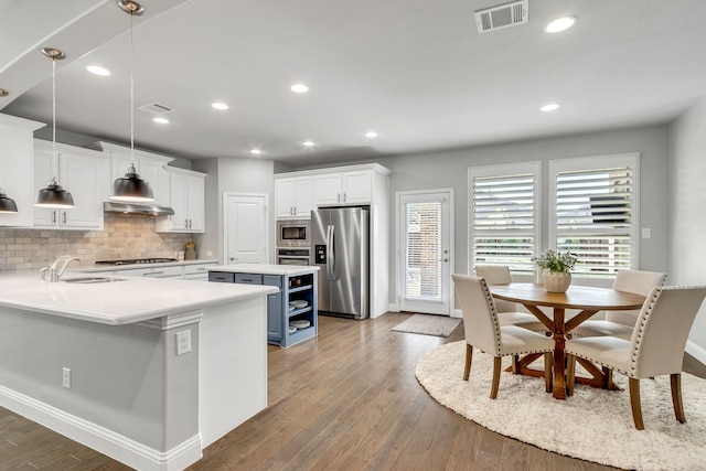 kitchen with white cabinetry, pendant lighting, and appliances with stainless steel finishes