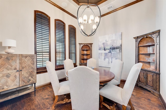 dining space with ornamental molding, dark hardwood / wood-style flooring, a notable chandelier, and a raised ceiling