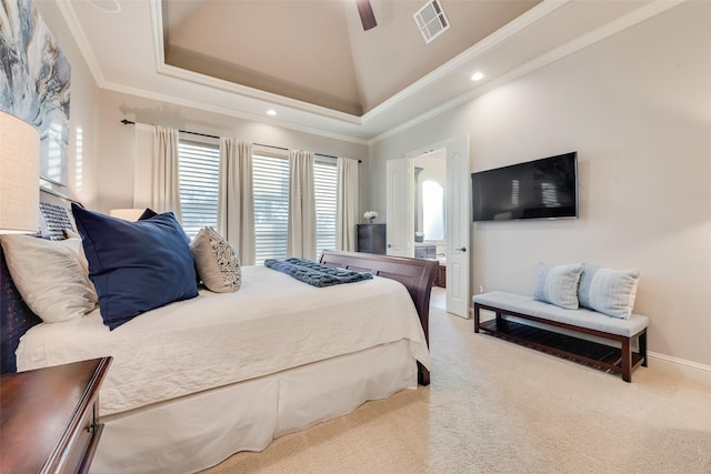 carpeted bedroom featuring a towering ceiling, ceiling fan, a tray ceiling, and crown molding