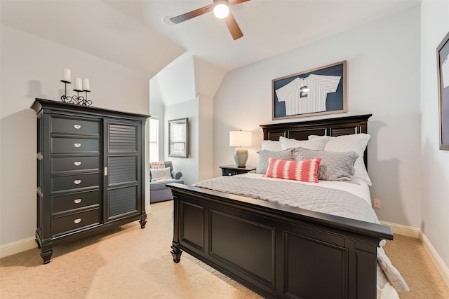 carpeted bedroom with ceiling fan and vaulted ceiling