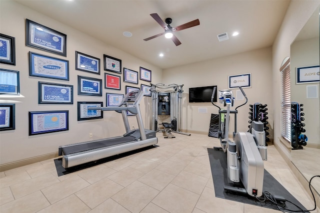 workout room with ceiling fan and light tile patterned floors