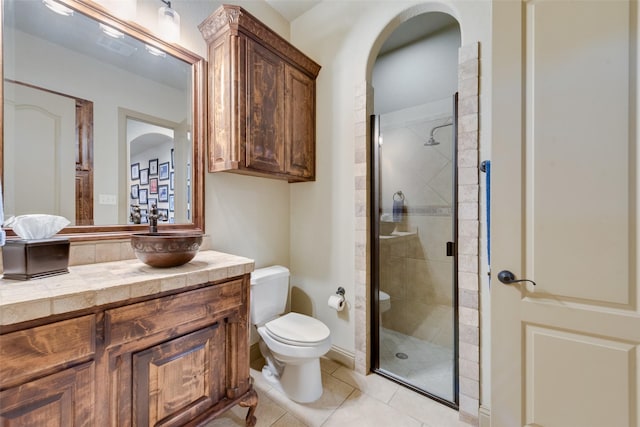 bathroom with toilet, walk in shower, tile patterned floors, and vanity