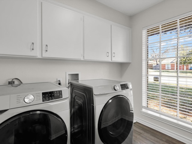 laundry room with cabinets, plenty of natural light, dark hardwood / wood-style floors, and independent washer and dryer