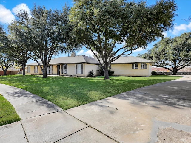 ranch-style home with a front lawn