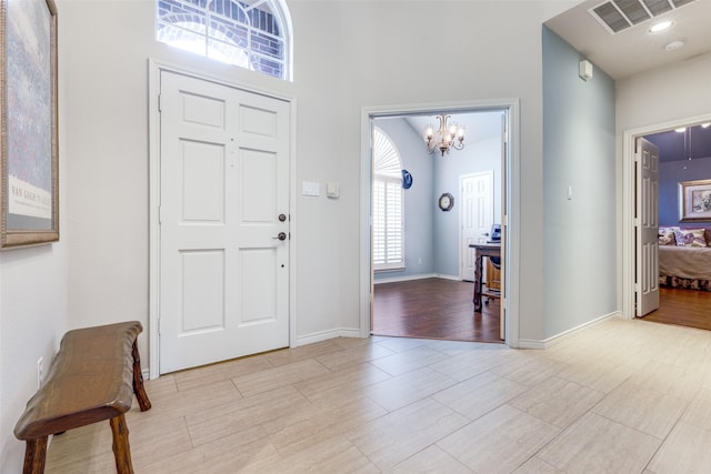 foyer entrance with a notable chandelier