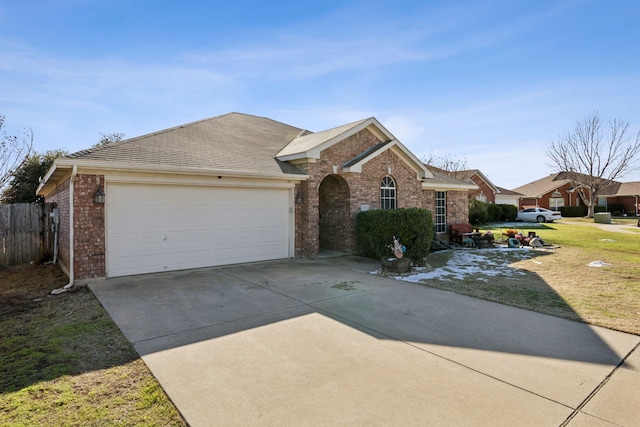 ranch-style house featuring a front yard and a garage