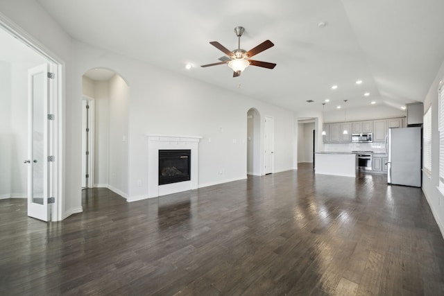 unfurnished living room with dark wood-type flooring and ceiling fan