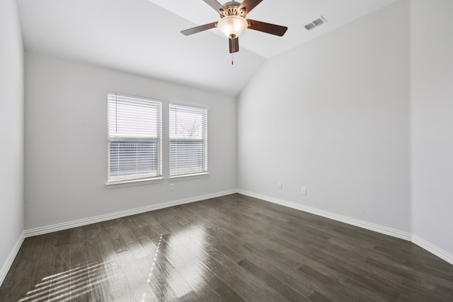 spare room featuring ceiling fan, dark hardwood / wood-style flooring, and vaulted ceiling