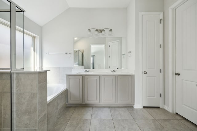 bathroom featuring tile patterned flooring, plus walk in shower, vaulted ceiling, and vanity