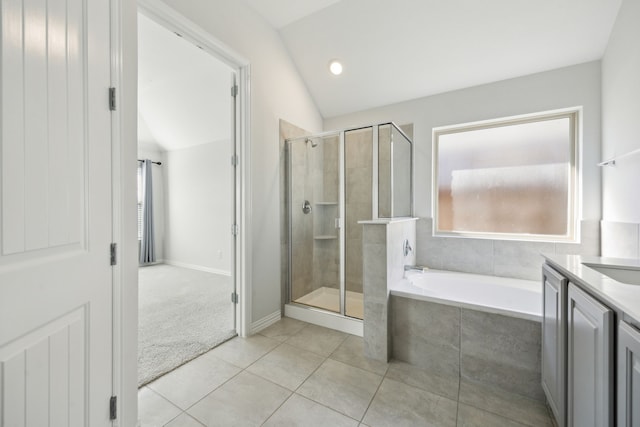 bathroom featuring tile patterned flooring, plus walk in shower, vaulted ceiling, and vanity