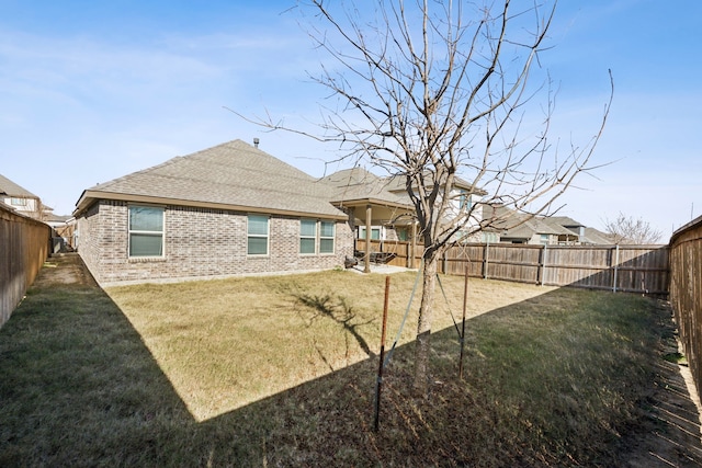 rear view of house featuring a yard