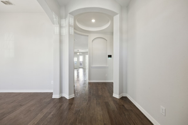 corridor with dark hardwood / wood-style flooring