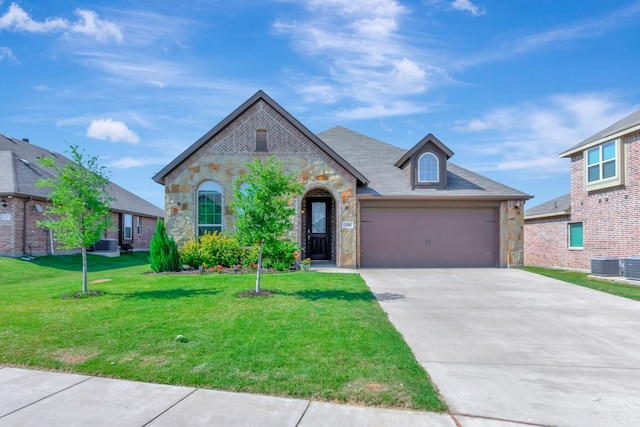 view of front of home with a garage and a front lawn