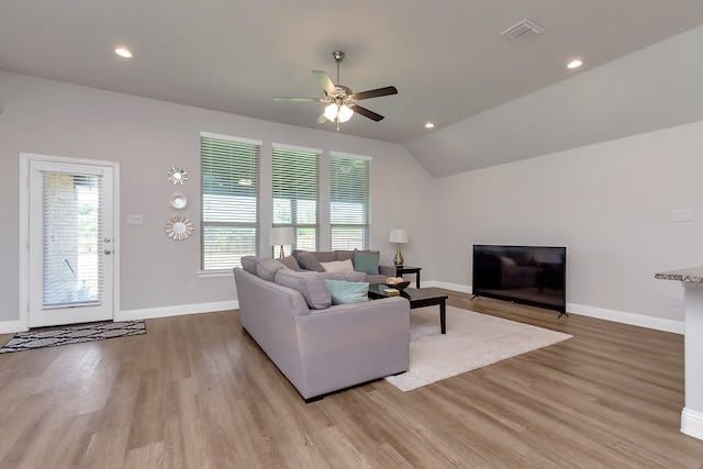 living room featuring light hardwood / wood-style floors, ceiling fan, and lofted ceiling