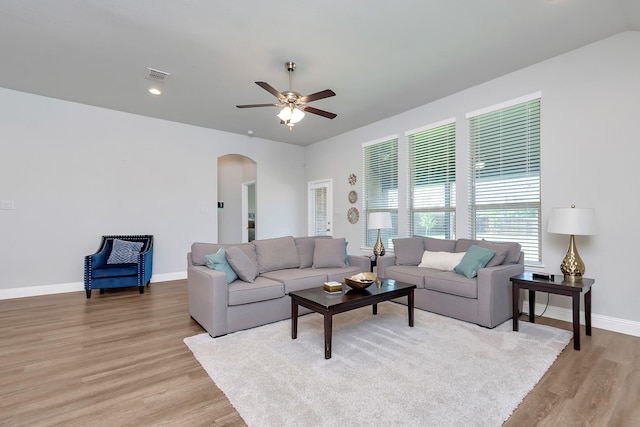 living room featuring ceiling fan and light hardwood / wood-style flooring