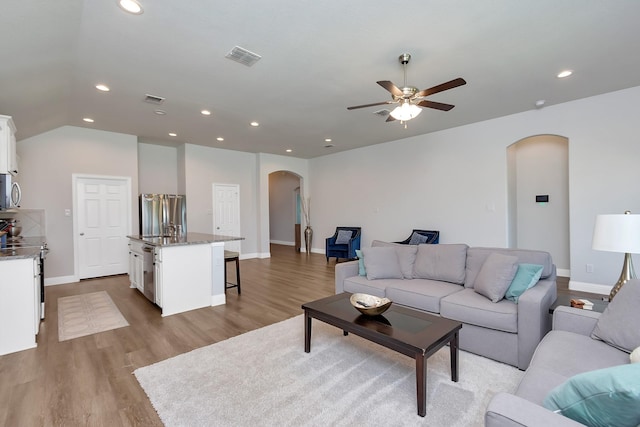 living room featuring ceiling fan and light hardwood / wood-style flooring