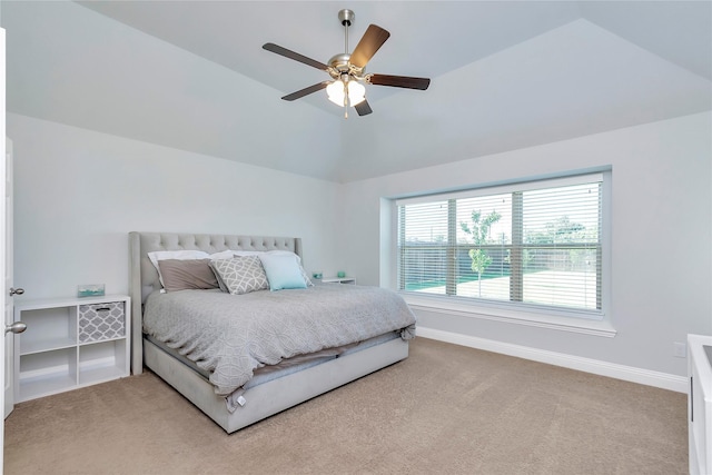 carpeted bedroom featuring lofted ceiling and ceiling fan