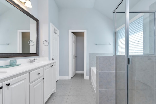 bathroom with vanity, tile patterned flooring, vaulted ceiling, and separate shower and tub