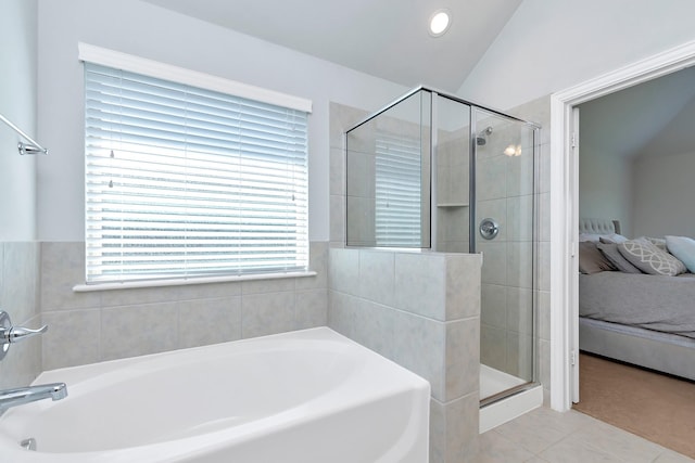 bathroom with lofted ceiling, tile patterned floors, and independent shower and bath