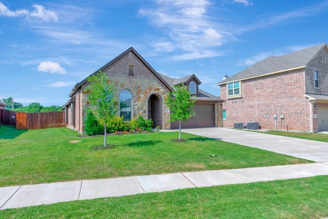 view of front of home with central air condition unit and a front yard