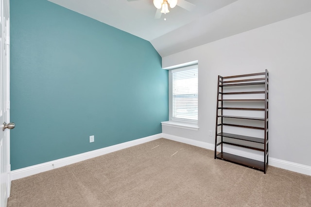 unfurnished bedroom featuring lofted ceiling, ceiling fan, and light colored carpet