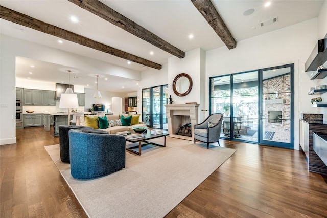 living room featuring light hardwood / wood-style floors and beam ceiling