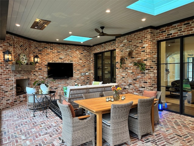 view of patio with ceiling fan and an outdoor brick fireplace