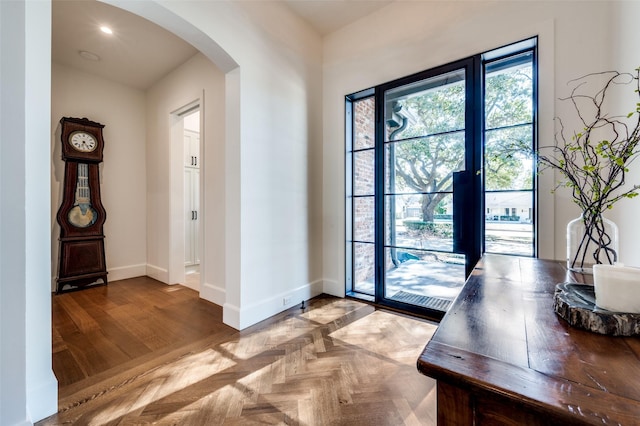 entryway featuring parquet flooring