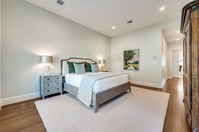 bedroom with dark hardwood / wood-style flooring