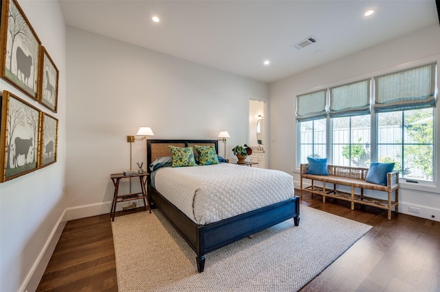 bedroom with dark hardwood / wood-style floors