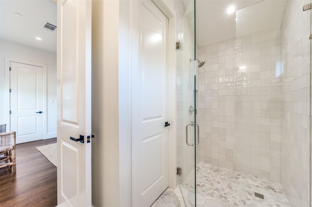 bathroom featuring a shower with shower door