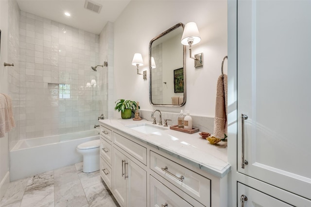 full bathroom with toilet, tiled shower / bath, and vanity