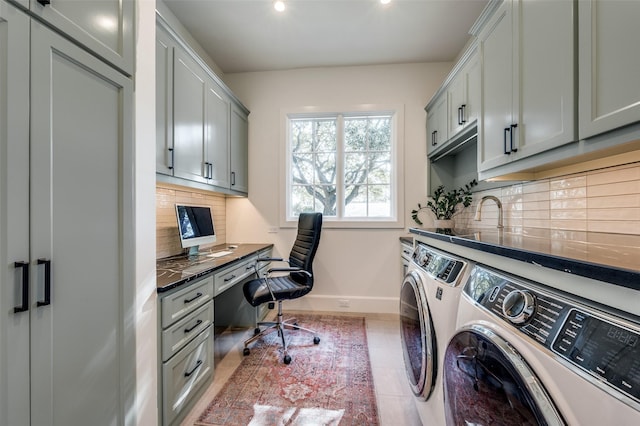 laundry area featuring tile patterned flooring, cabinets, and washer and clothes dryer