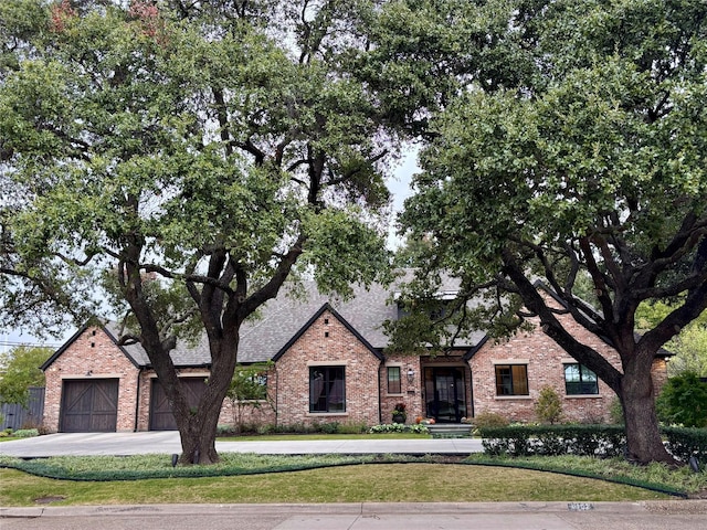 view of front of home with a front lawn and a garage