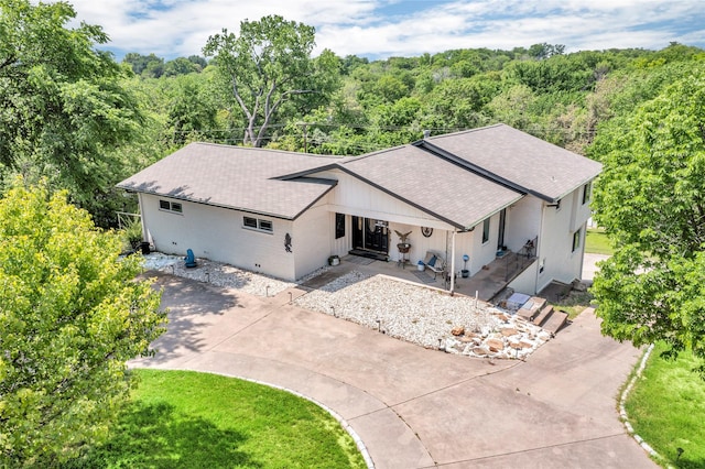 drone / aerial view with a wooded view