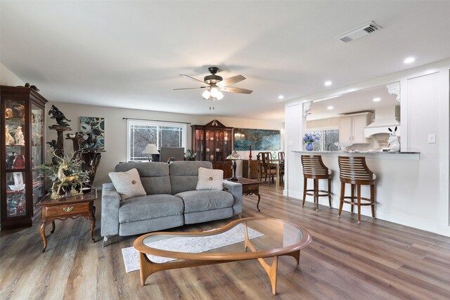 back of property with a balcony, ceiling fan, and a yard