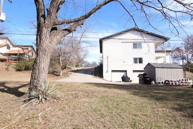 rear view of property with a lawn and a garage