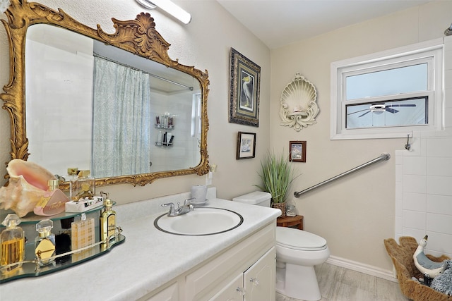 bathroom with toilet, a shower with shower curtain, hardwood / wood-style flooring, and vanity