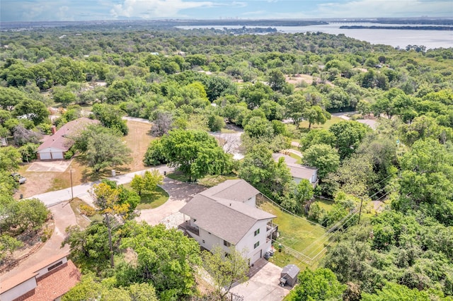aerial view featuring a forest view and a water view
