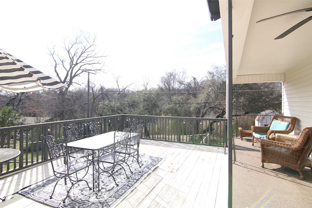 wooden terrace featuring ceiling fan and outdoor dining area