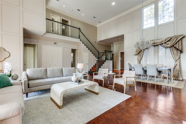 living room featuring a high ceiling, crown molding, and dark parquet floors