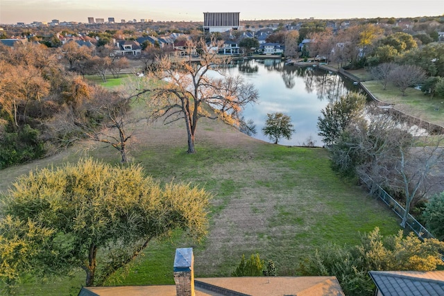 aerial view at dusk featuring a water view