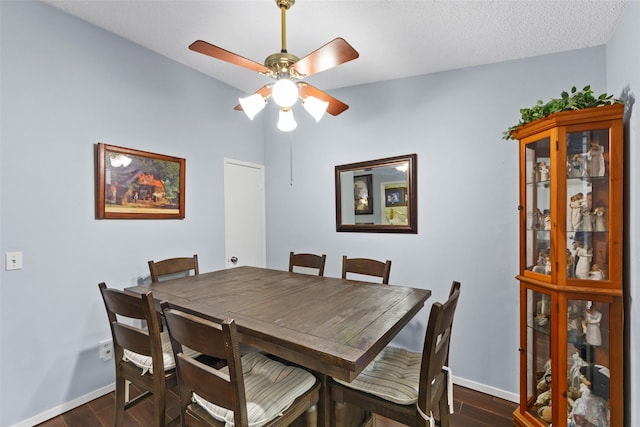 dining space featuring ceiling fan and dark wood-type flooring